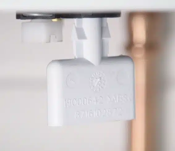 A close up look of a light gray plastic appliance component